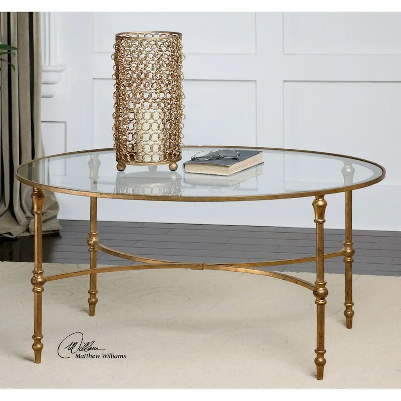 Tavolino ovale Uttermost Vitya – Base in ferro battuto con finitura foglia oro, piano in vetro temperato, 40"L
